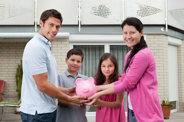 Picture of a family with a piggy bank