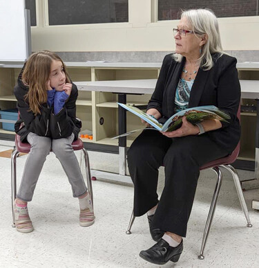 Picture of a student and a teacher reading