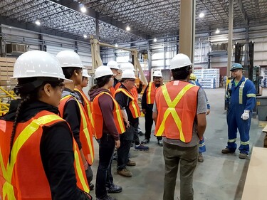 Group of people with safety jackets and hard hats on