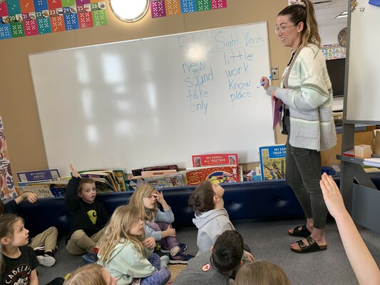 Teacher working with elementary students