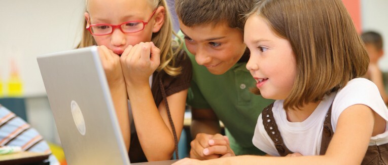 picture of kids looking at a laptop